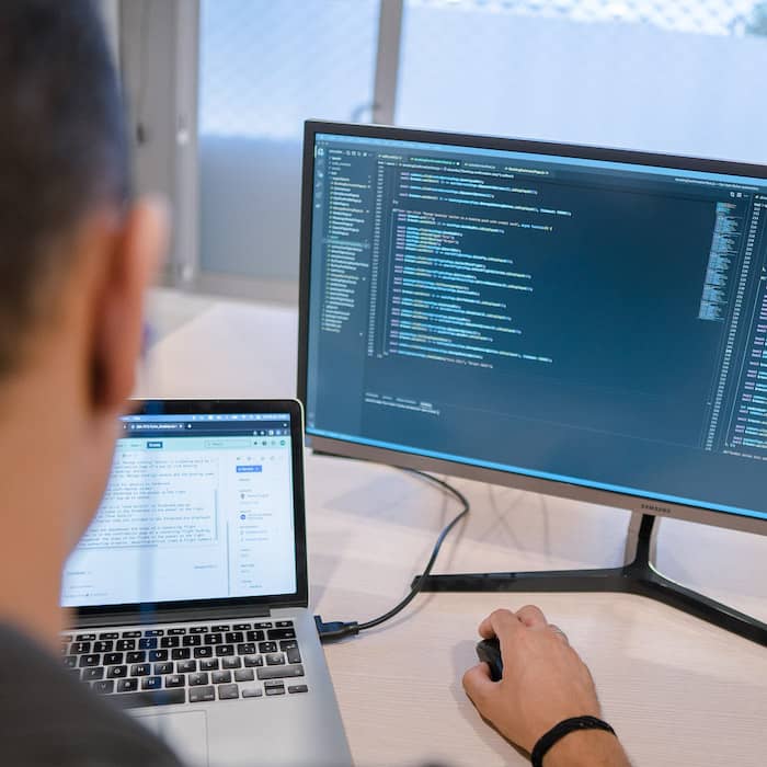 Redsauce employees doing cybersecurity audit on a laptop